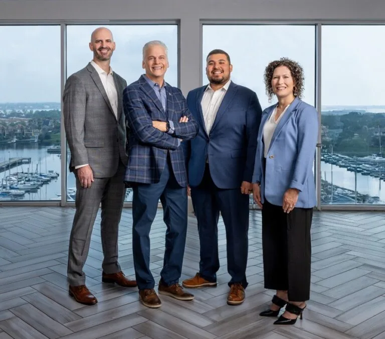 The Burrows Financial leadership team at their waterfront office in Texas
